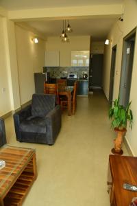 a living room with a couch and a table at Nirantara Luxury Service Apartment in Gonikoppal