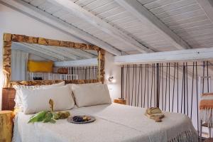 a bedroom with a bed with a plate of food on it at Casale Tasciotto in Genazzano