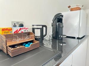 a kitchen counter with a coffee maker on a counter top at The Wold - Air-Conditionned Studio Burton Latimer in Burton Latimer