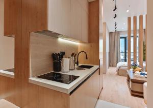a kitchen with a stove top oven next to a living room at Modern Spaces U-Tower in Tashkent