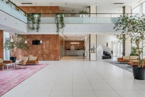 an empty lobby of a building with furniture and plants at Premier Kraków Hotel in Krakow