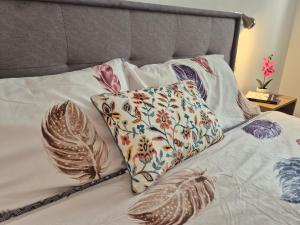 a bed with two pillows on top of it at Luna chalet Zlatibor in Zlatibor