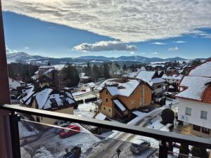 a view of a town with snow covered roofs at Luna chalet Zlatibor in Zlatibor