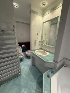 a bathroom with two sinks and a tub and two toilets at FRASCATI Suites in Frascati +24 photos