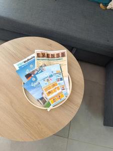 a wooden table with a newspaper on top of it at Casa Gaumaise & Casa Cool in Virton