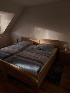 a bedroom with two beds and two night stands at Weingut Christian Bechtel in Klüsserath