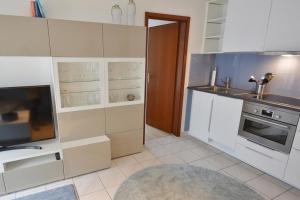 a kitchen with white cabinets and a sink at Titania Whg 7 in Grömitz