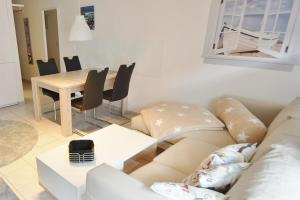 a living room with a couch and a table at Titania Whg 7 in Grömitz