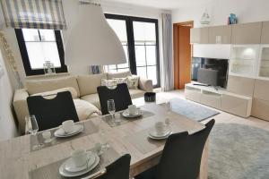 a kitchen and living room with a table and chairs at Titania Whg 7 in Grömitz