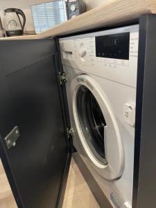 a washing machine in a kitchen with a counter at Weymouths Coastal Nook in Weymouth