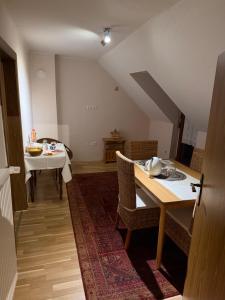 a living room with a table and a dining room at Weingut Christian Bechtel in Klüsserath +4 photos