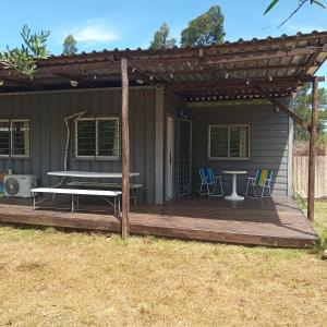a house with a wooden deck with a table and chairs at Casa a 100 nts del mar in Balneario Argentino