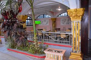 a restaurant with a table and chairs and a plant at lynna hôtel in Yaoundé