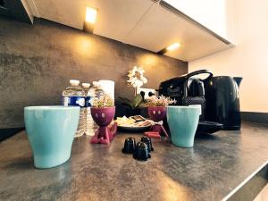 a counter top with two cups and a coffee maker at Relaxed City 1BR Apartment in Luxembourg