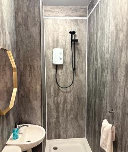 a bathroom with a shower and a sink at Piccolo in Glasgow