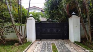 a black gate in front of a house at Home Stay by 98 in Dambulla