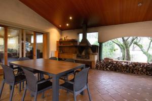 a dining room with a table and chairs and a fireplace at La Vinya de Mas Pujol in Suria