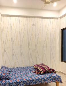 a bed in a room with a wooden wall at Siddhi's Inn in Prayagraj