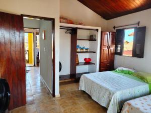 a bedroom with a bed and a door to a hallway at Nascimento BEACH in Águas Belas