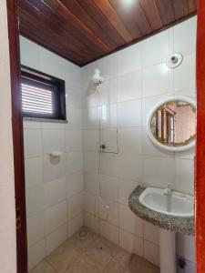 a bathroom with a sink and a mirror at Nascimento BEACH in Águas Belas