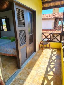a room with a door and a bed on a balcony at Nascimento BEACH in Águas Belas