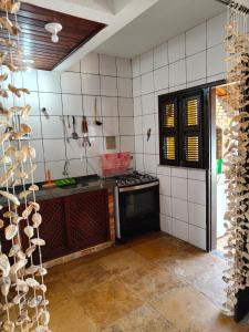 a kitchen with a counter and a stove top oven at Nascimento BEACH in Águas Belas +33 photos