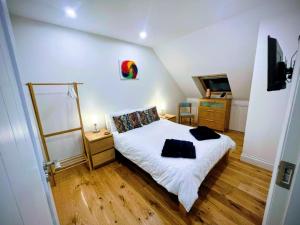 a small bedroom with a bed and a tv at 21KR Bed and Breakfast, close to beach, town centre and golf in St. Andrews