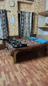 a large bed in a room with a wooden floor at Siddhi's Inn in Prayagraj