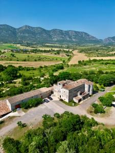 an aerial view of a building with mountains in the background at Domaine De Blancardy in Moulès-et-Baucels