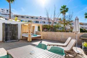 a patio with a gazebo and chairs at Haciendas Village Tenerife in Adeje