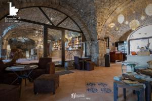 a store with a large archway in a brick building at Domaine De Blancardy in Moulès-et-Baucels