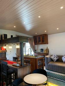a kitchen and living room with a table and a couch at Galkanda Walawwa Boutique Villa in Kandy