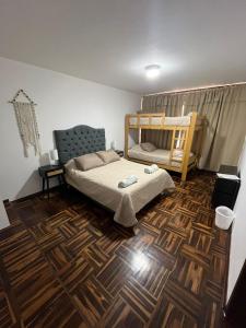 a bedroom with a bunk bed and a wooden floor at Harmony Inn Miraflores in Lima +120 photos
