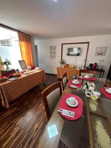 a dining room with a table with red napkins on it at Harmony Inn Miraflores in Lima