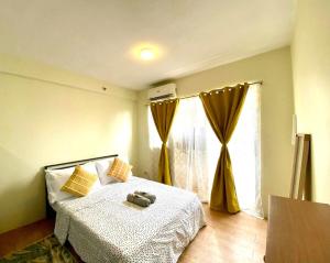 a bedroom with a bed and a large window at Chic Studio near Ocean Park in Cebu City +17 photos