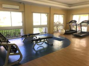a gym with several treadmills and exercise bikes in a room at Chic Studio near Ocean Park in Cebu City