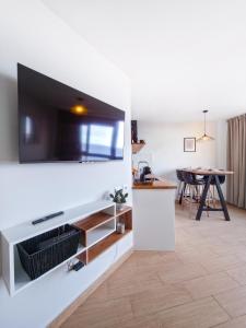 a living room with a large flat screen tv on a wall at Verana House in Arguineguín