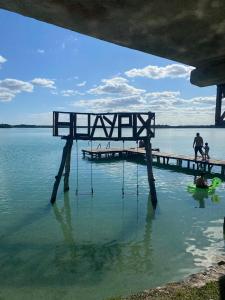 a bench sitting in the water next to a dock at Casa Ix Milagros in Huay Pix +11 photos