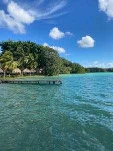 a pier on a tropical island in the water at Casa Ix Milagros in Huay Pix