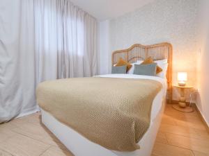 a bedroom with a large bed with pillows at Verana House in Arguineguín