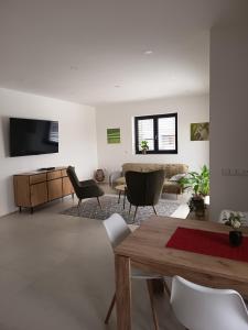 a living room with a couch and a table at Apartmány MB JARO Mladá Boleslav in Bradlec