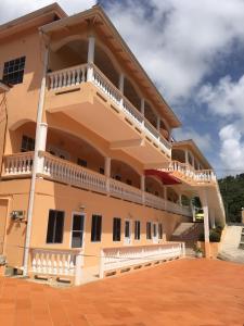 a building with balconies on the side of it at Aupic Paradise in Vieux Fort