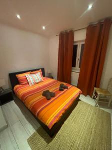 a bedroom with a large bed with a colorful blanket at Cozy house with garden in Mulhouse