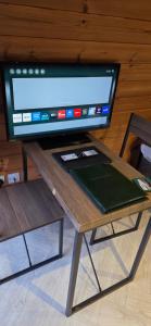 a table with a television on top of it at Priory Glamping Pods and Guest accommodation in Killarney