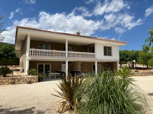a large white house with a porch and patio at Atidos vakantie appartementen in Ontinyent