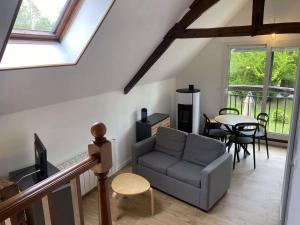 a living room with a couch and a table at La fermette du Marais in Rue