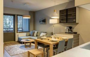 a living room with a table and a couch at Ylläs Chalets IV 4309 in Ylläsjärvi