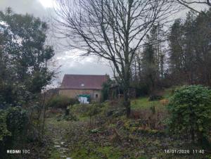 a house sitting on top of a hill in a field at La Chambre Périgourdine in Journiac +3 photos