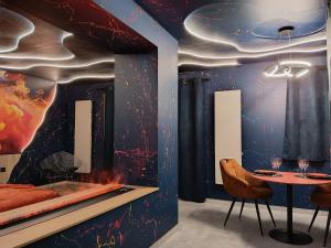 a dining room with a space themed wall at Love Room avec Jacuzzi Privatif Loft Sensation Romantique in Renwez +21 photos