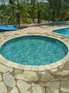 a large swimming pool with blue water at Chácara Cristo Rei in Senador Canedo